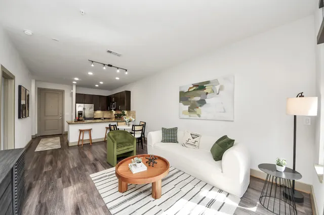 a view of a patio with table and chairs and potted plants with wooden floor and fence