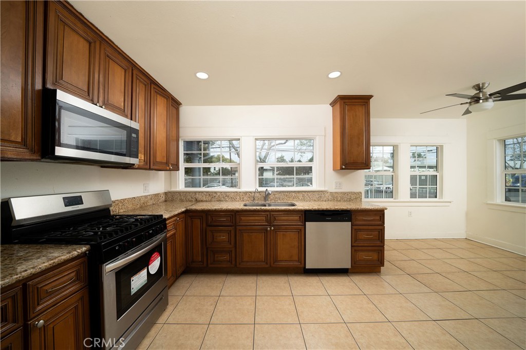 201 South Orange Avenue Santa Ana, CA 92701 - Photo 4 of 6 a kitchen with stainless steel appliances granite countertop a stove a sink and a microwave