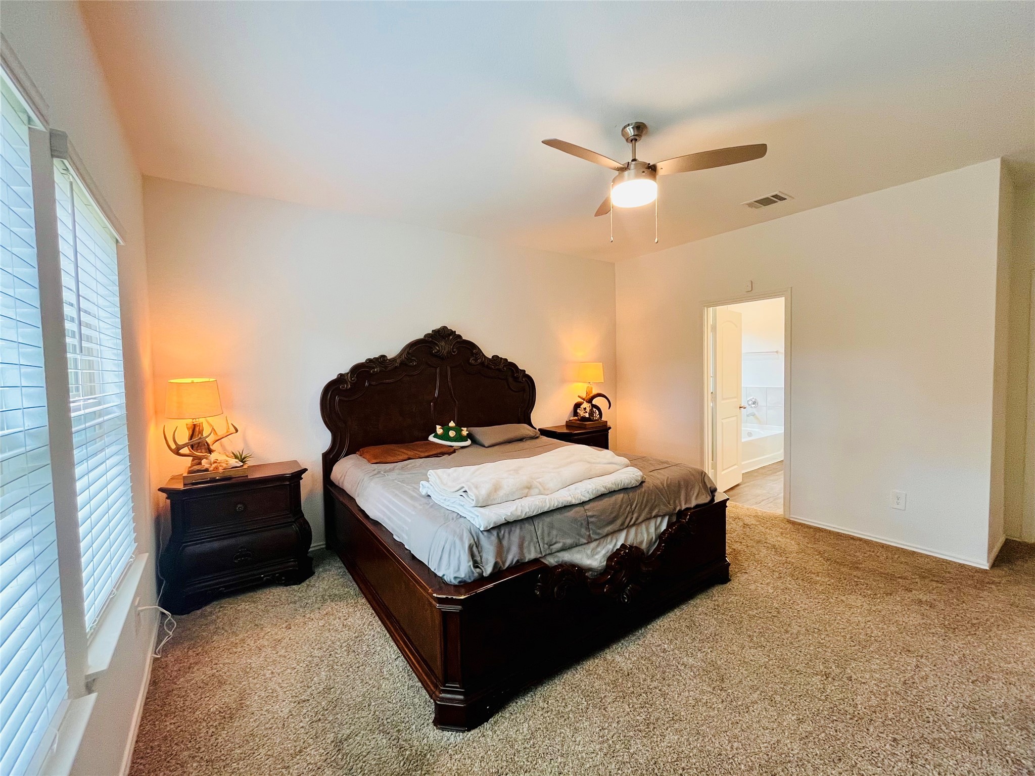 2914 Roman Forest Boulevard New Caney, TX 77357 - Photo 18 of 35 a spacious bedroom with a bed and window