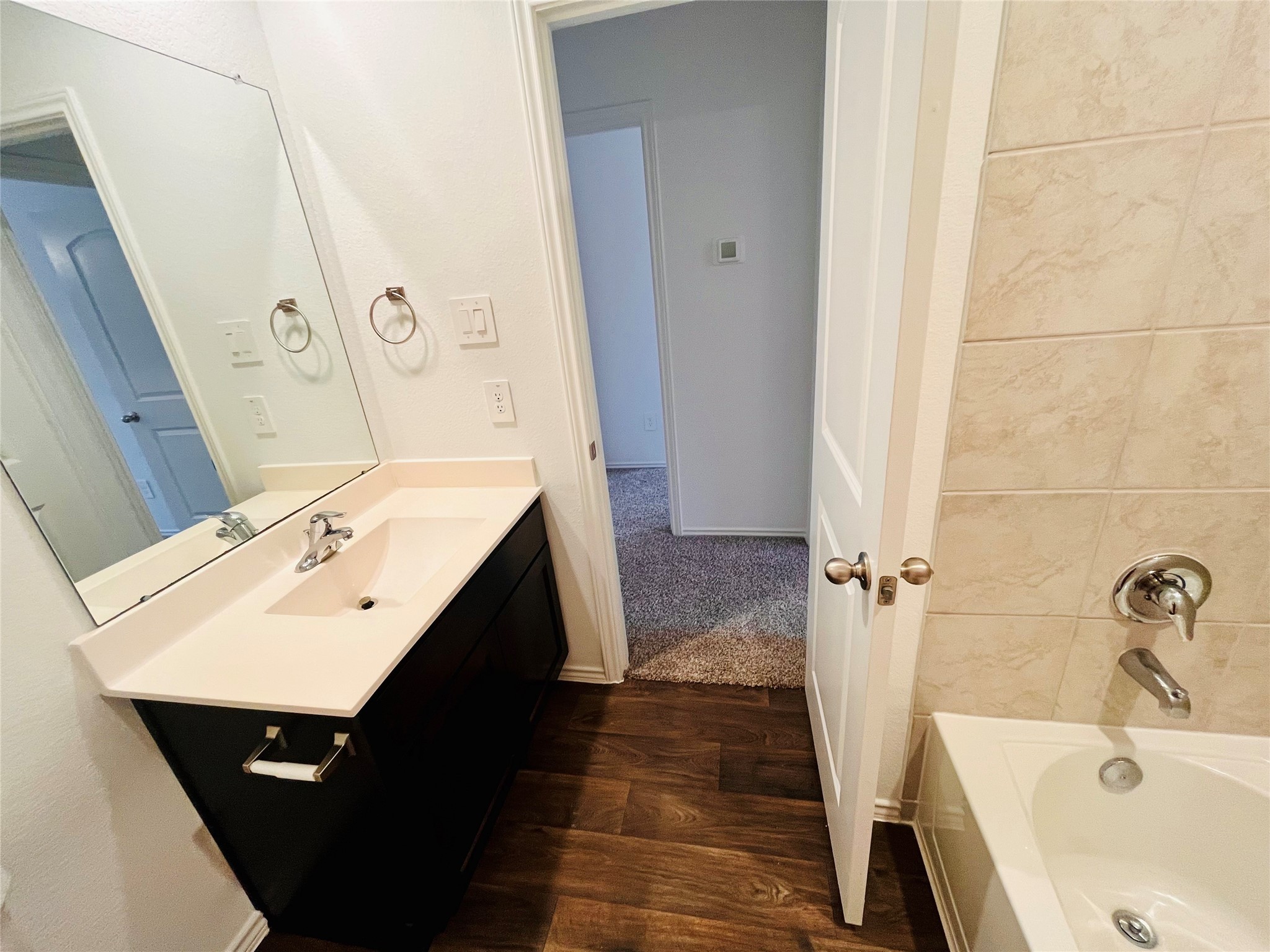 2914 Roman Forest Boulevard New Caney, TX 77357 - Photo 28 of 35 a bathroom with a sink a mirror and a bathtub
