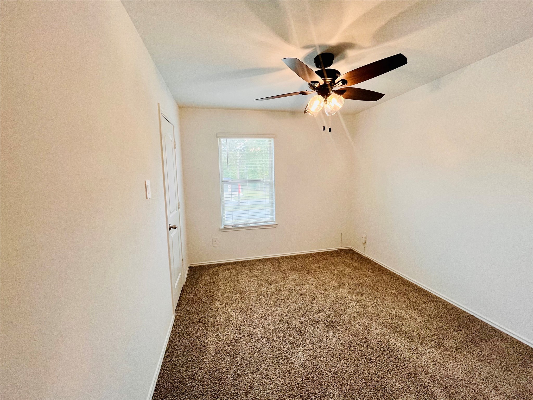 2914 Roman Forest Boulevard New Caney, TX 77357 - Photo 31 of 35 an empty room with windows and fan