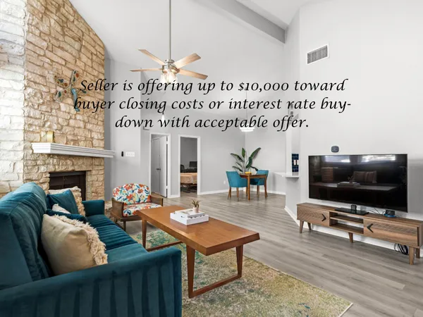 a living room with furniture a flat screen tv and a fireplace