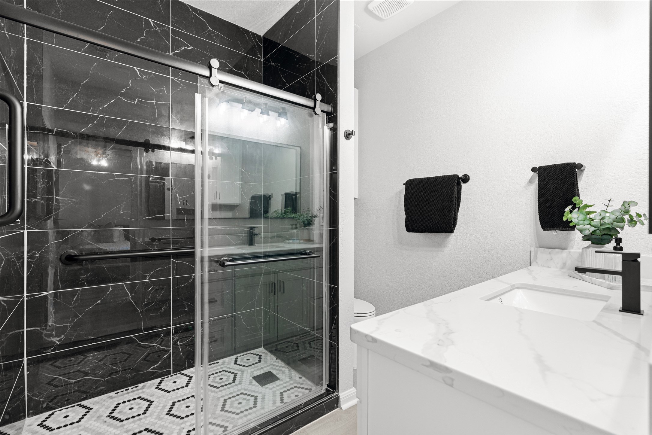 6501 Brush Country Road, Unit 137 Austin, TX 78749 - Photo 20 of 34 a bathroom with a shower sink and mirror