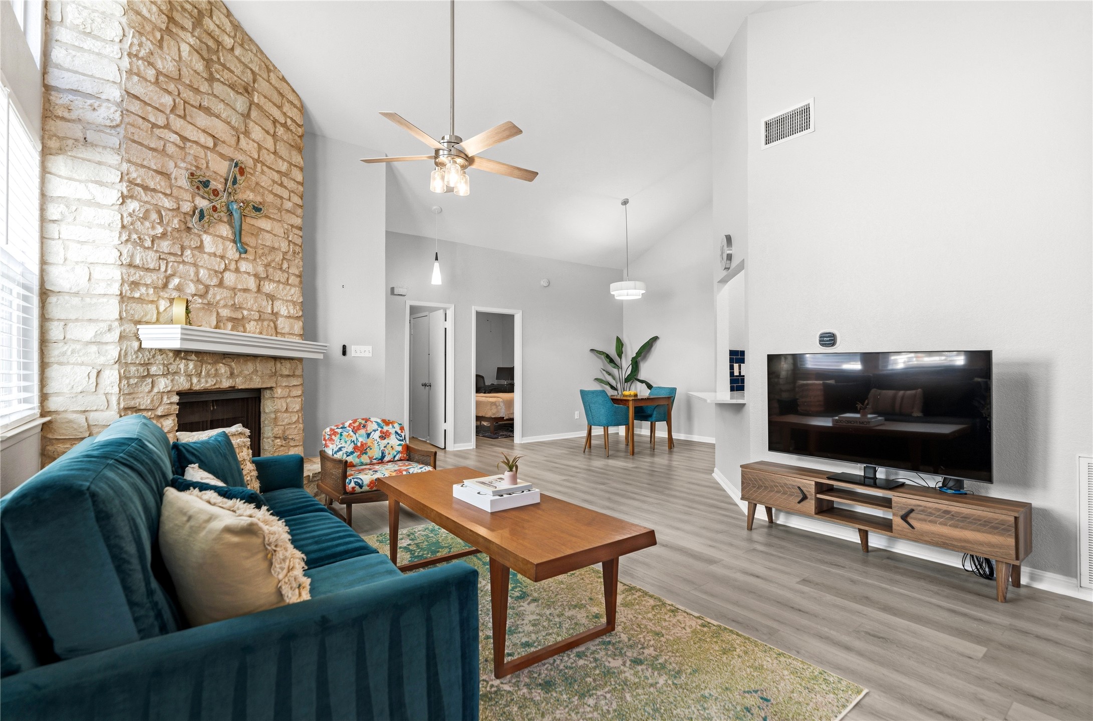 6501 Brush Country Road, Unit 137 Austin, TX 78749 - Photo 2 of 34 a living room with furniture a flat screen tv and a fireplace