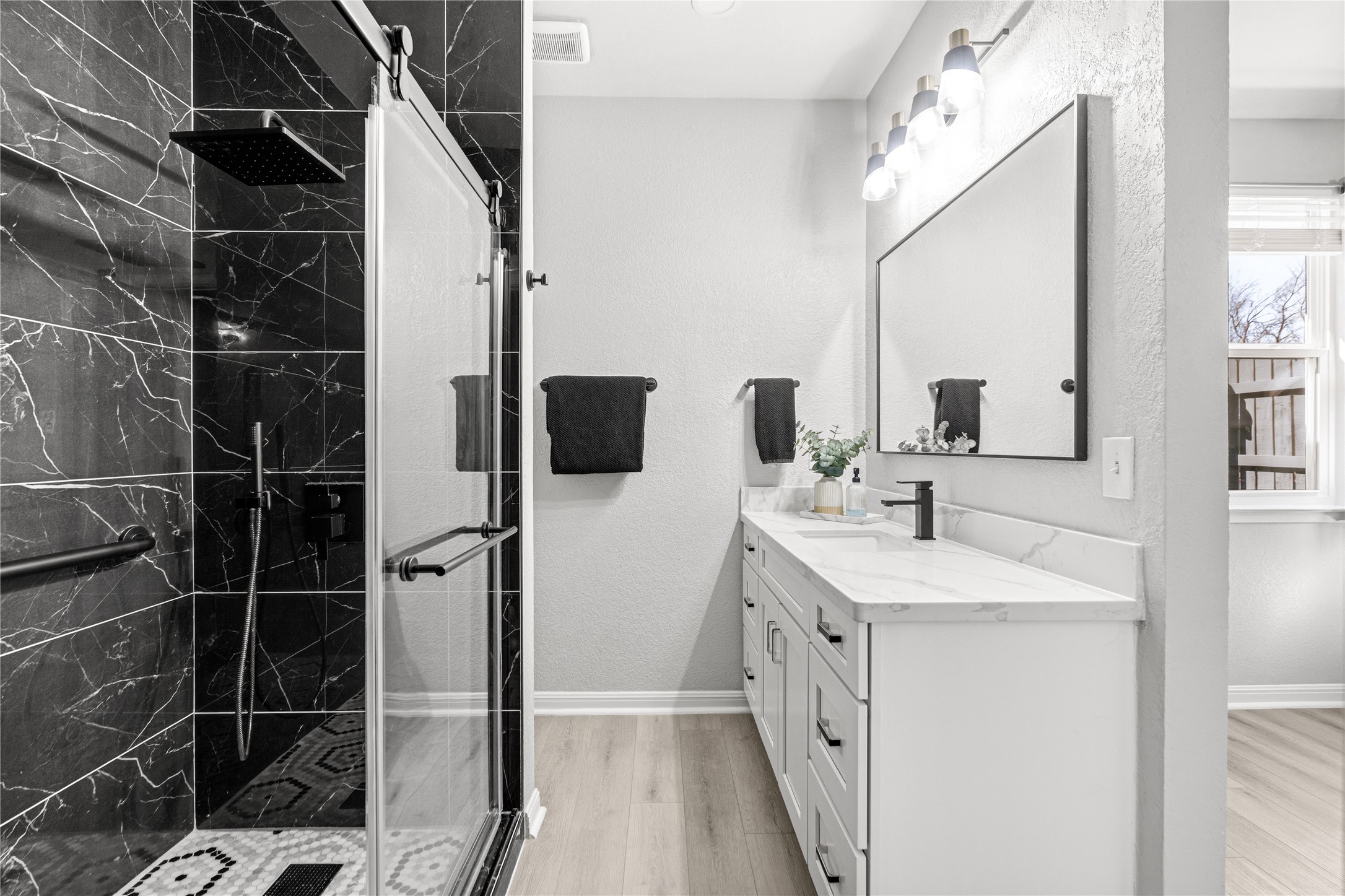 6501 Brush Country Road, Unit 137 Austin, TX 78749 - Photo 21 of 34 a bathroom with a double vanity sink a mirror and a shower