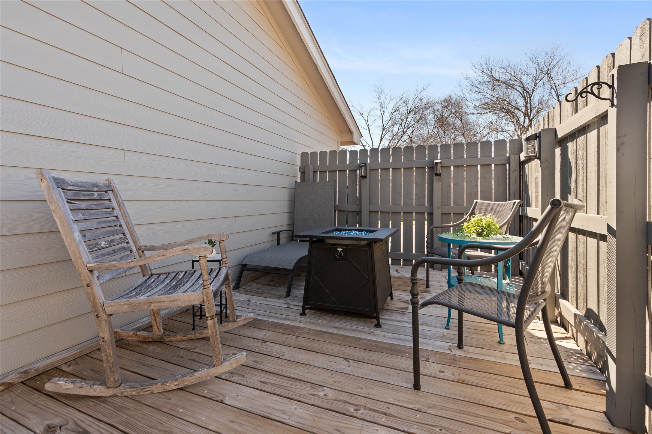 6501 Brush Country Road, Unit 137 Austin, TX 78749 - Photo 28 of 34 a view of a chairs and table on the wooden floor in front of a house