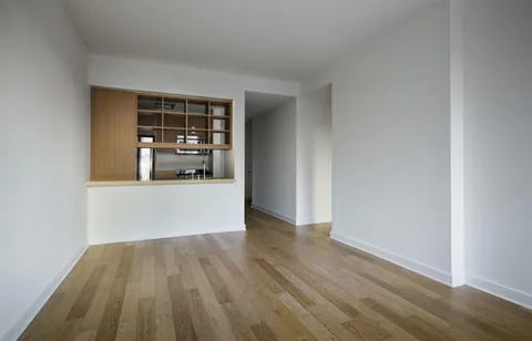 a view of a living room with wooden floor