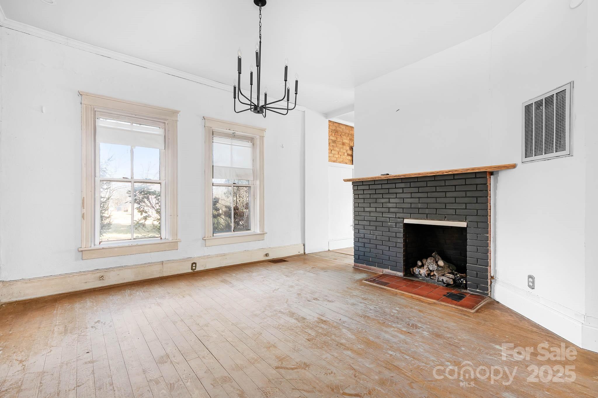 787 Startown Road Lincolnton, NC 28092 - Photo 11 of 33 a view of a livingroom with wooden floor a fireplace and window
