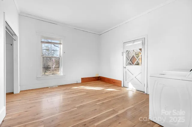 a bedroom with a bed and painting on the wall