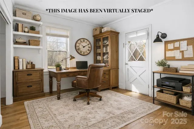 a view of a workspace with furniture and a window