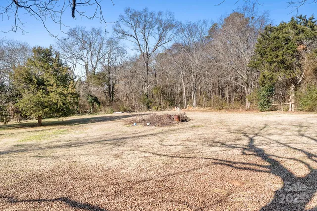 a view of a house with a yard covered in snow