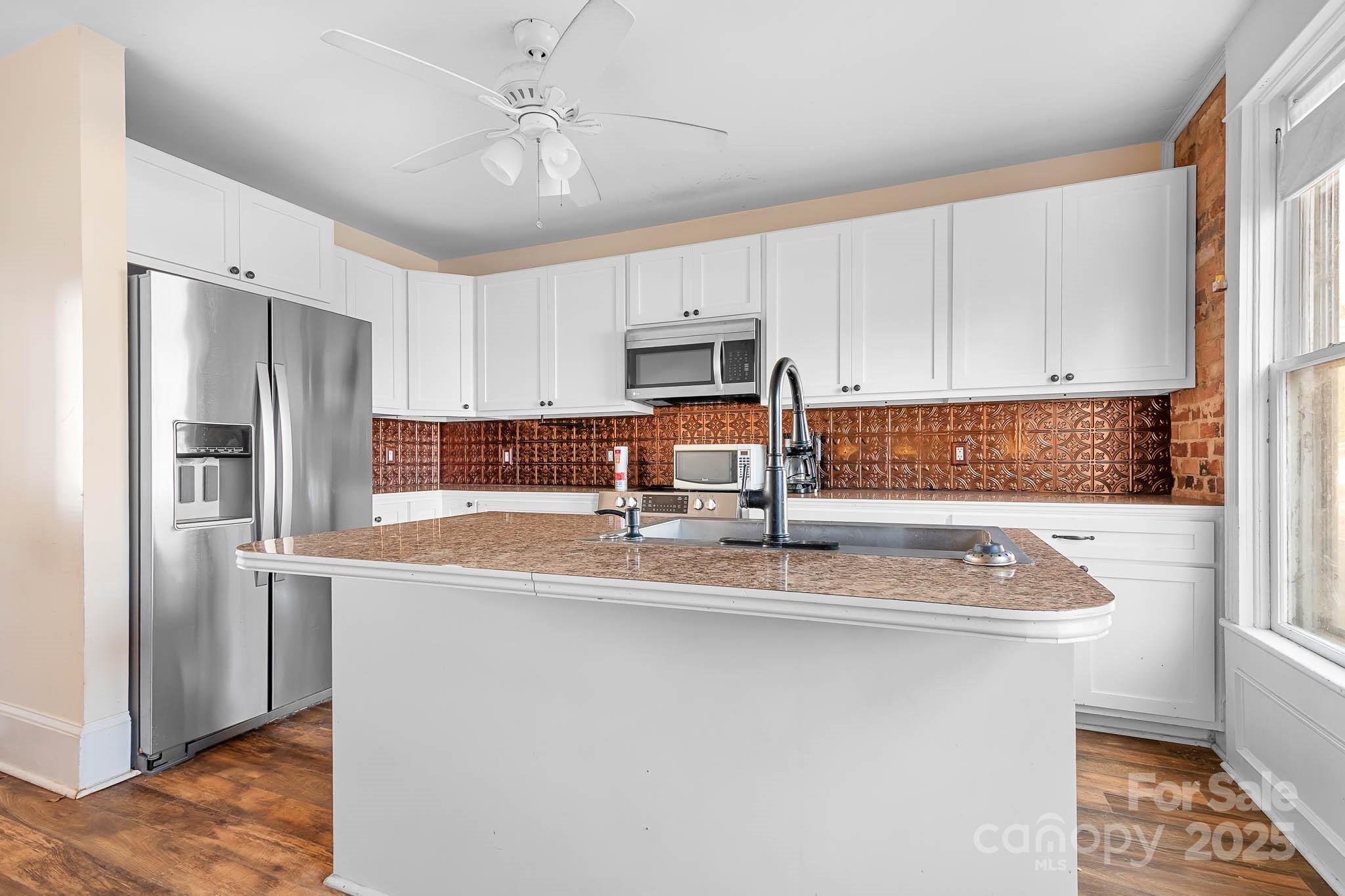787 Startown Road Lincolnton, NC 28092 - Photo 4 of 33 a kitchen with stainless steel appliances granite countertop a sink stove and refrigerator