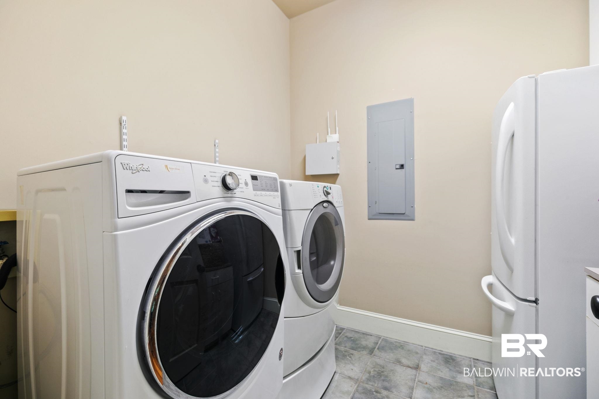 202 Beall Lane Daphne, AL 36526 - Photo 31 of 46 Laundry room featuring washing machine and dryer, electric panel, and light tile patterned floors