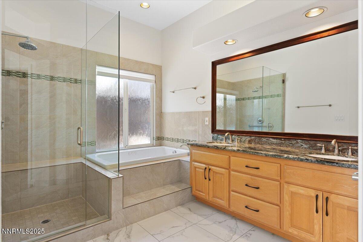 5024 East Albuquerque Road Reno, NV 89511 - Photo 16 of 27 a spacious bathroom with a granite countertop sink mirror and shower