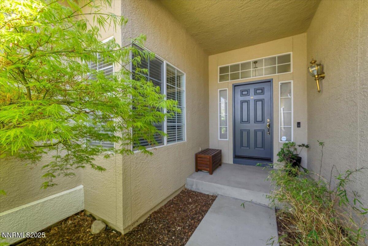 5024 East Albuquerque Road Reno, NV 89511 - Photo 2 of 27 a view of house with backyard door and glass door