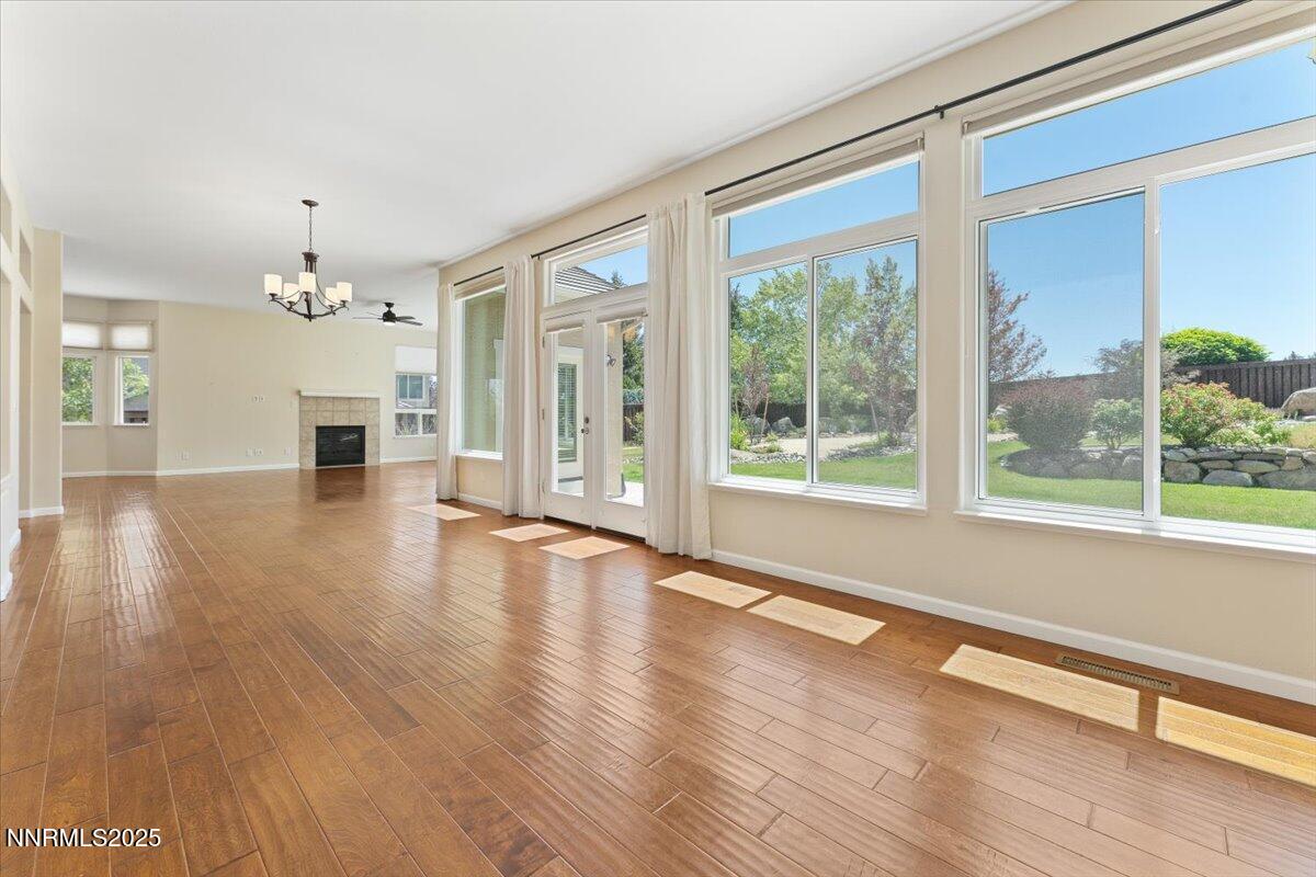 5024 East Albuquerque Road Reno, NV 89511 - Photo 5 of 27 a view of a big room with wooden floor fireplace and windows