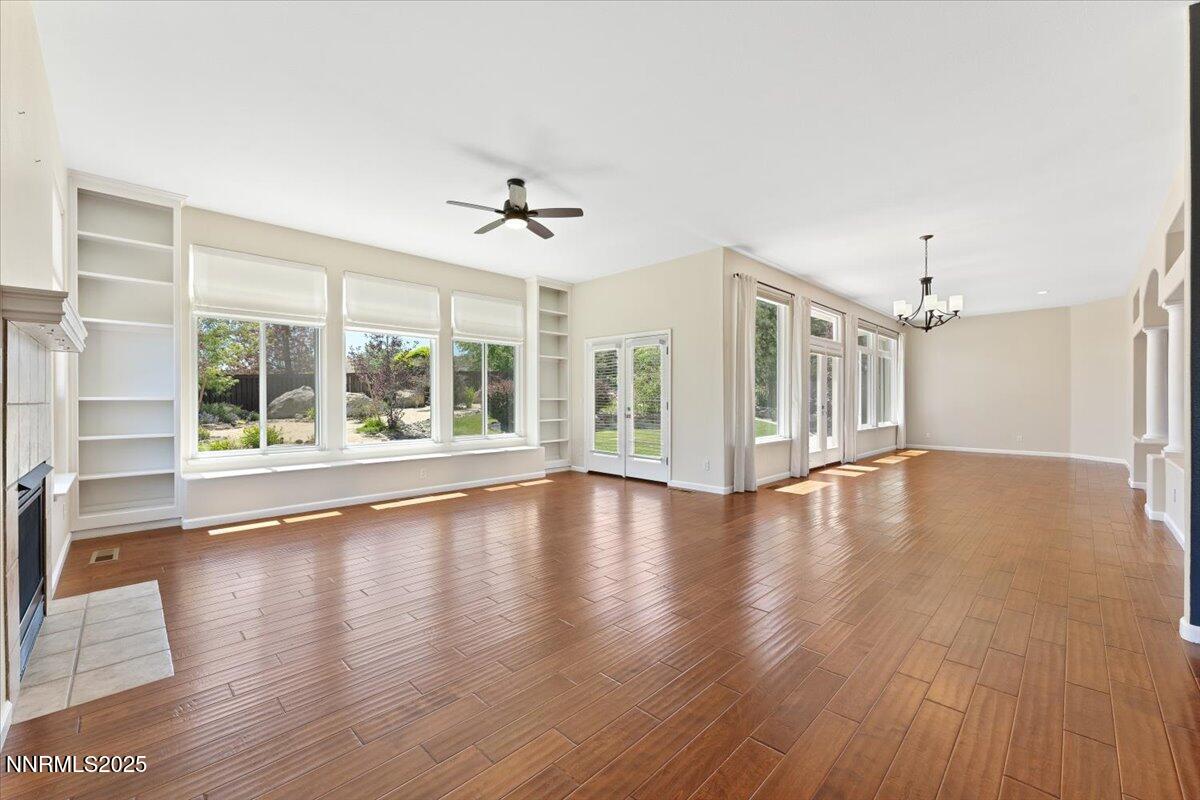 5024 East Albuquerque Road Reno, NV 89511 - Photo 6 of 27 a view of an empty room with wooden floor and a window