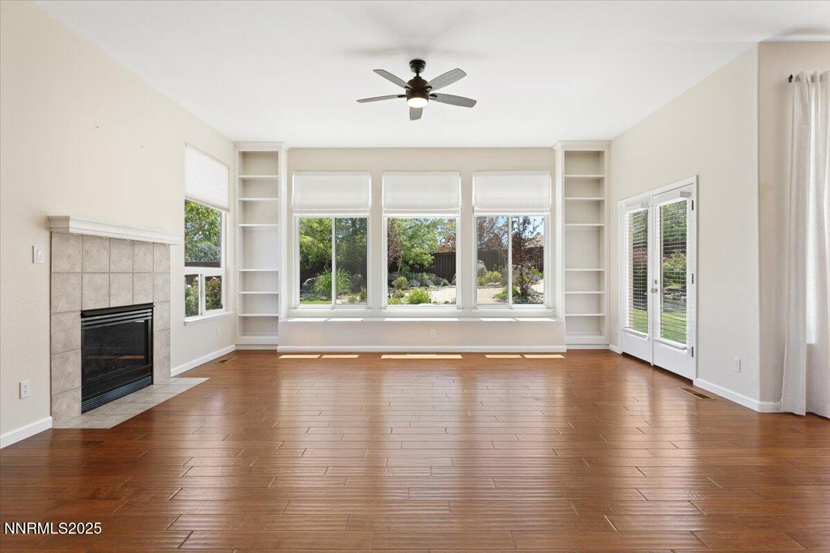 5024 East Albuquerque Road Reno, NV 89511 - Photo 8 of 27 a view of an empty room with wooden floor and a fireplace
