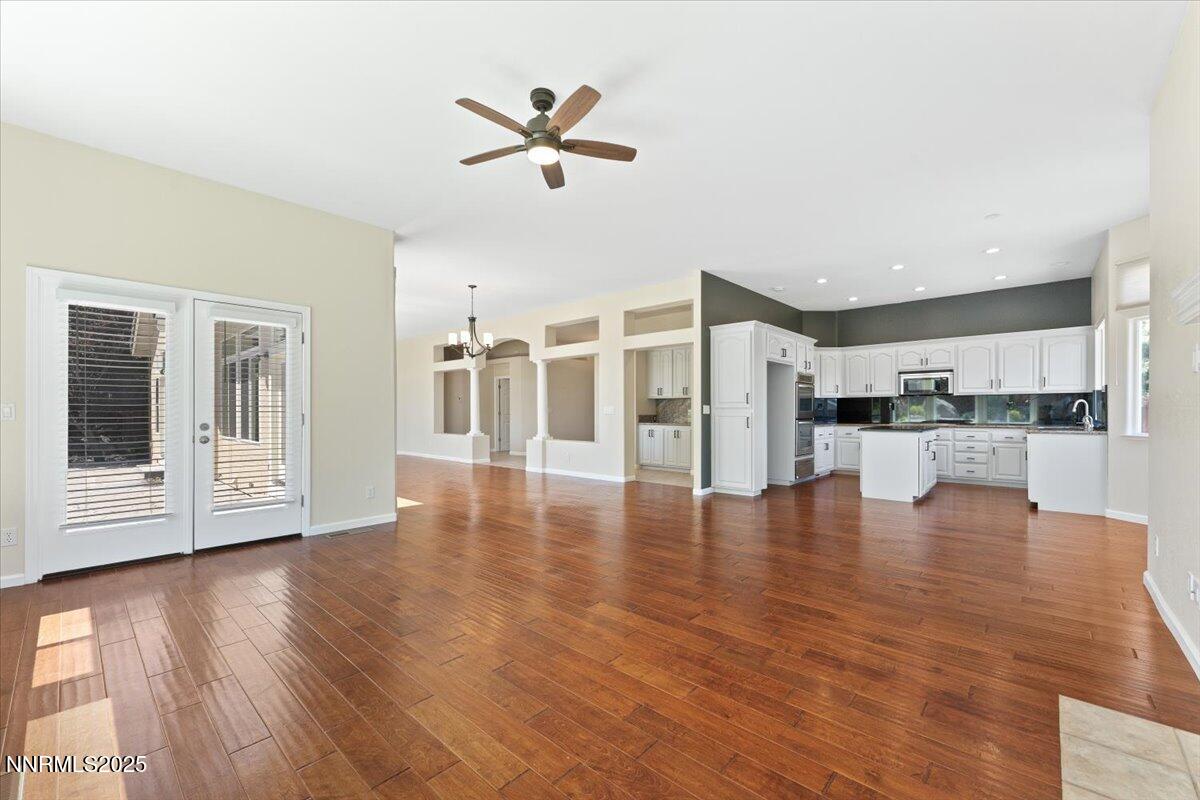 5024 East Albuquerque Road Reno, NV 89511 - Photo 9 of 27 a view of a living room a kitchen with furniture and wooden floor