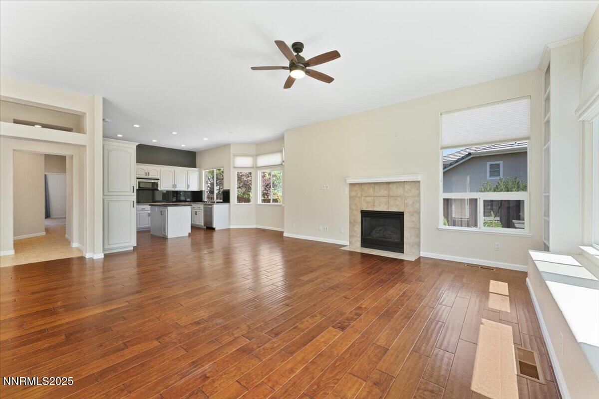 5024 East Albuquerque Road Reno, NV 89511 - Photo 10 of 27 a view of a kitchen with furniture a ceiling fan and wooden floor