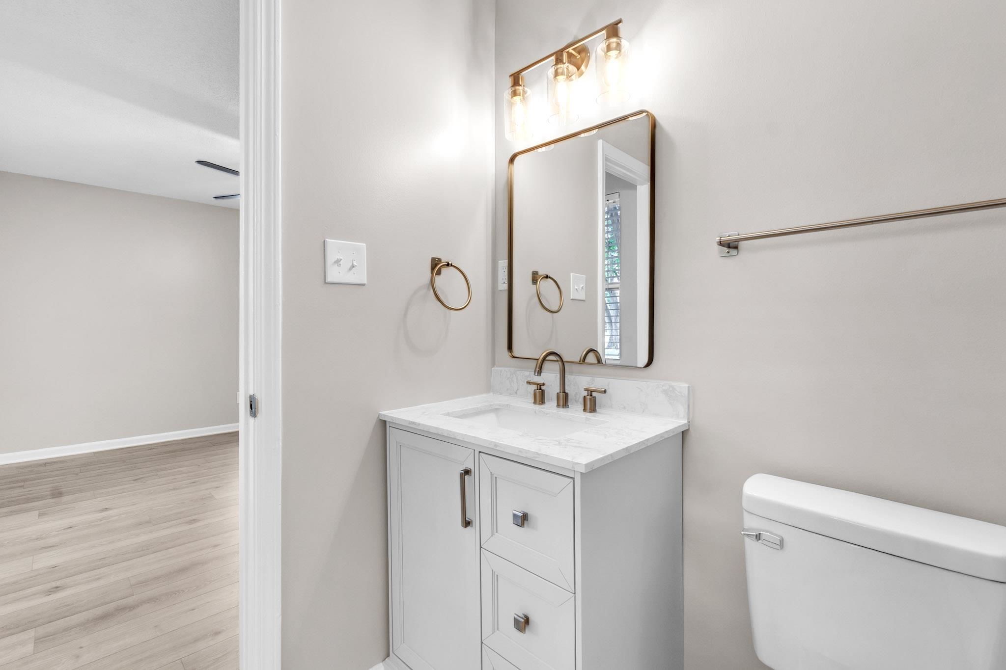 Half bath featuring vanity and light wood-type flooring