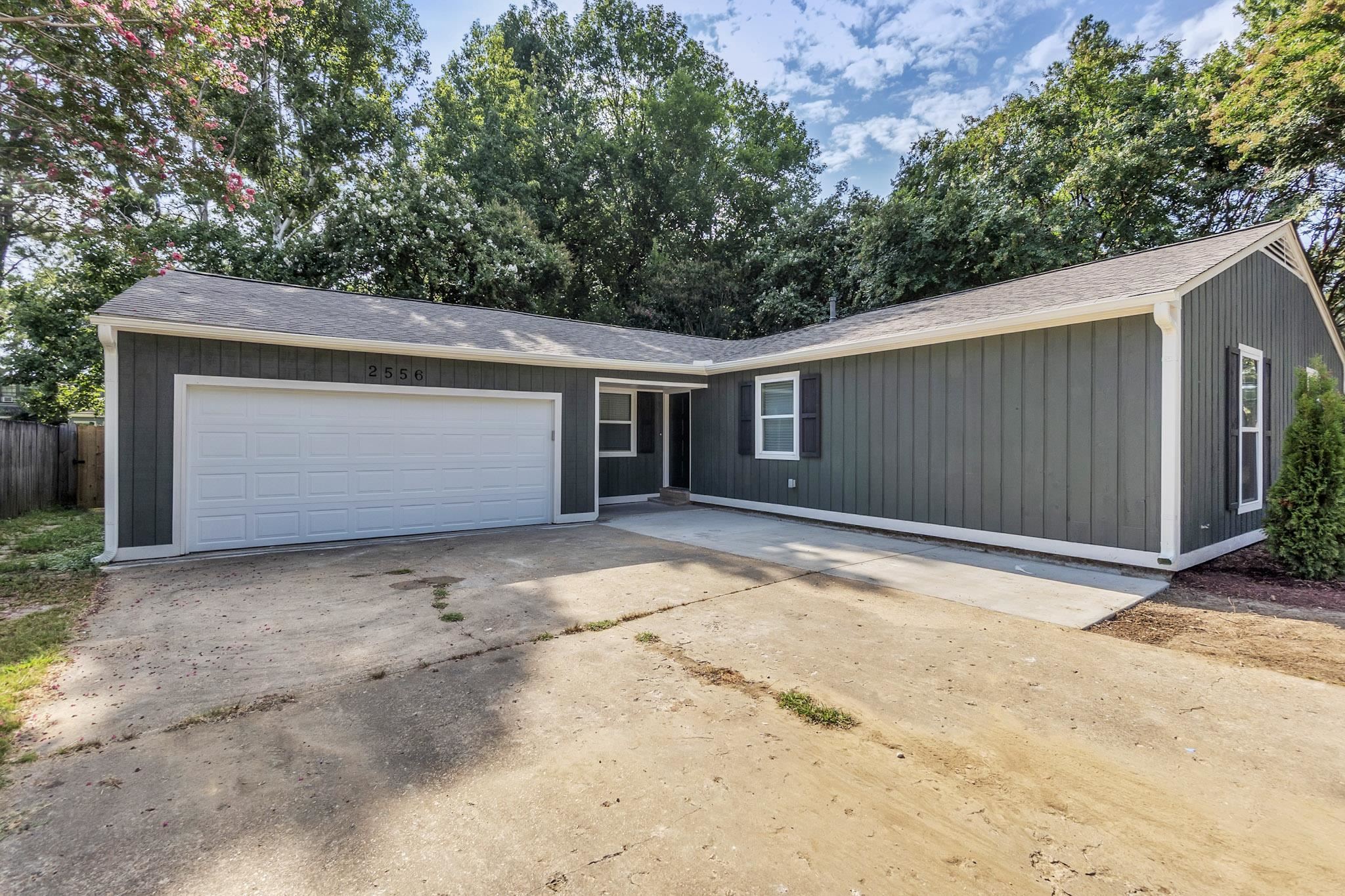 2556 Lynnfield Road Memphis, TN 38119 - Photo 12 of 24 View of front facade featuring roof with shingles, a garage, and driveway