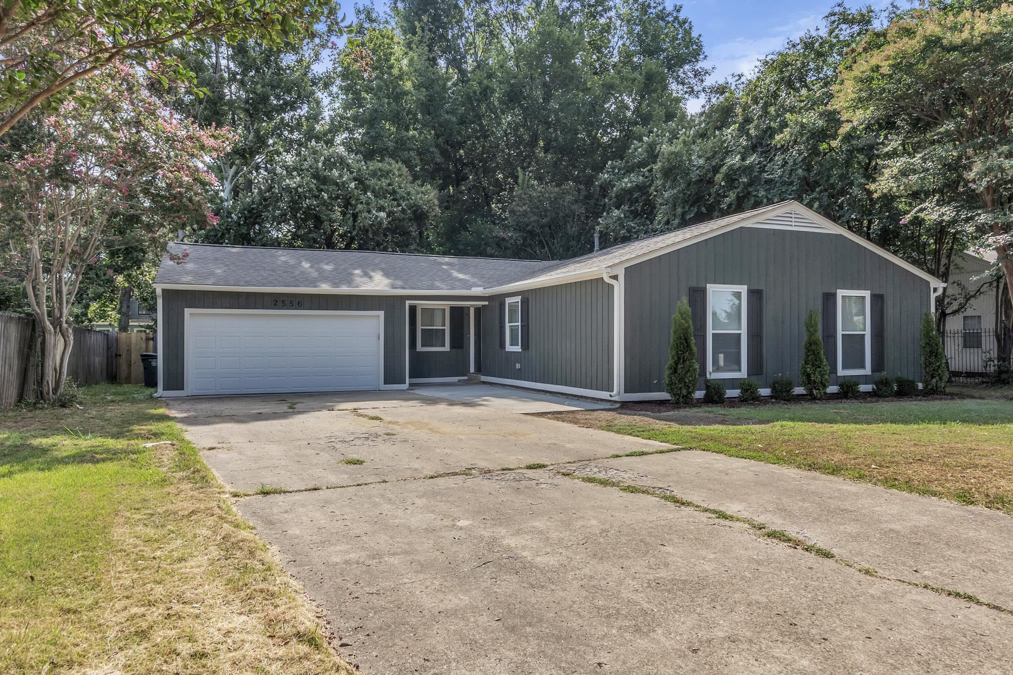 2556 Lynnfield Road Memphis, TN 38119 - Photo 13 of 24 Ranch-style home with a garage, driveway, and a shingled roof