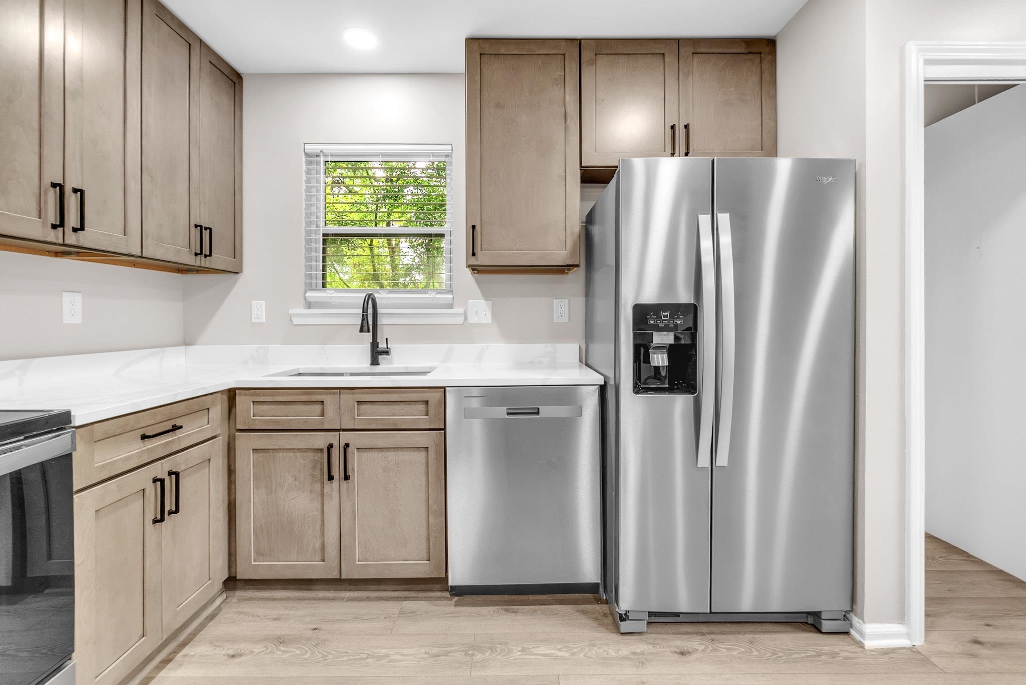 2556 Lynnfield Road Memphis, TN 38119 - Photo 20 of 24 Kitchen featuring stainless steel appliances, light wood-type flooring, light stone counters, and recessed lighting
