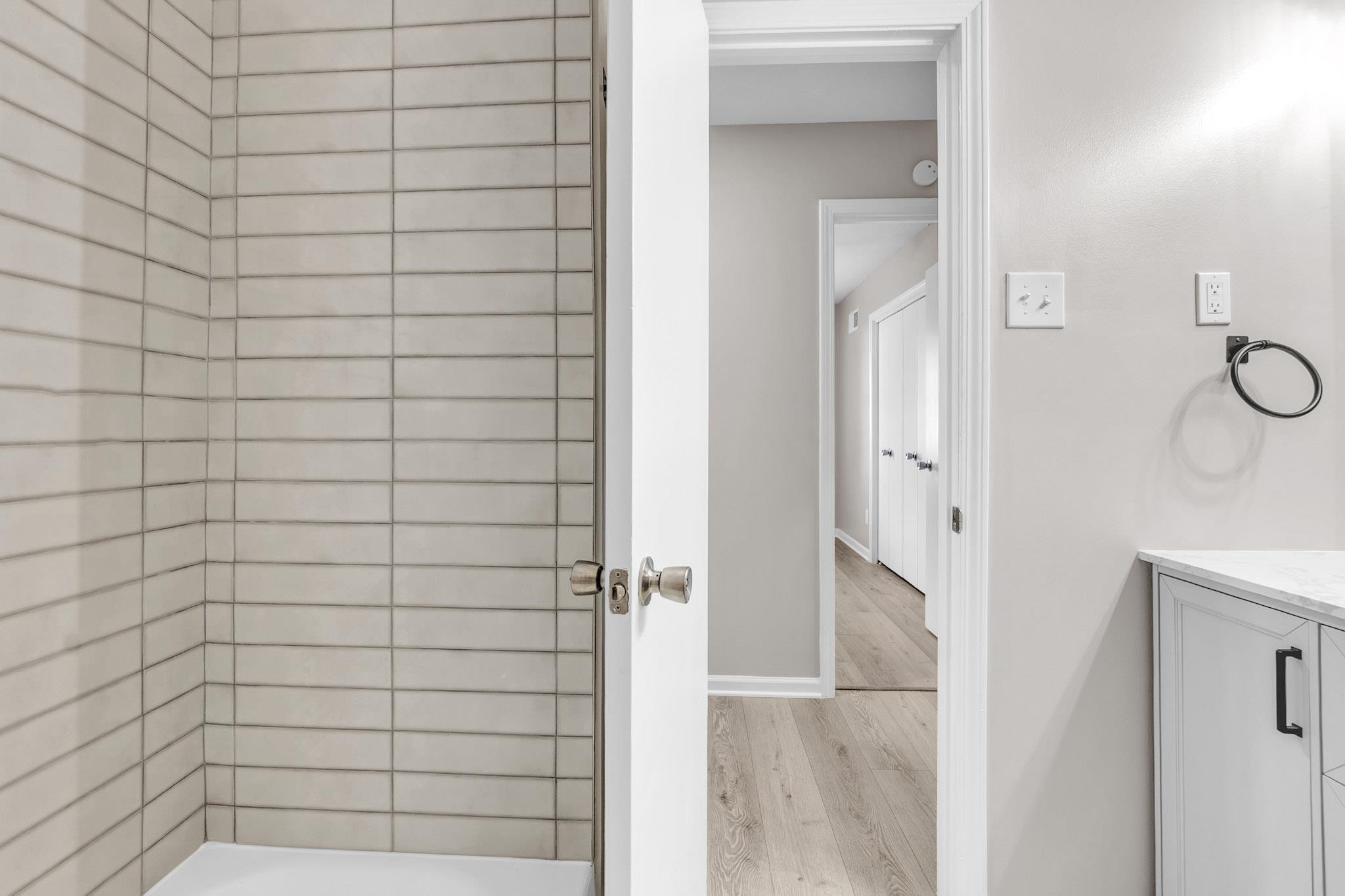 2556 Lynnfield Road Memphis, TN 38119 - Photo 3 of 24 Full bathroom featuring vanity, wood finished floors, and shower / bathtub combination
