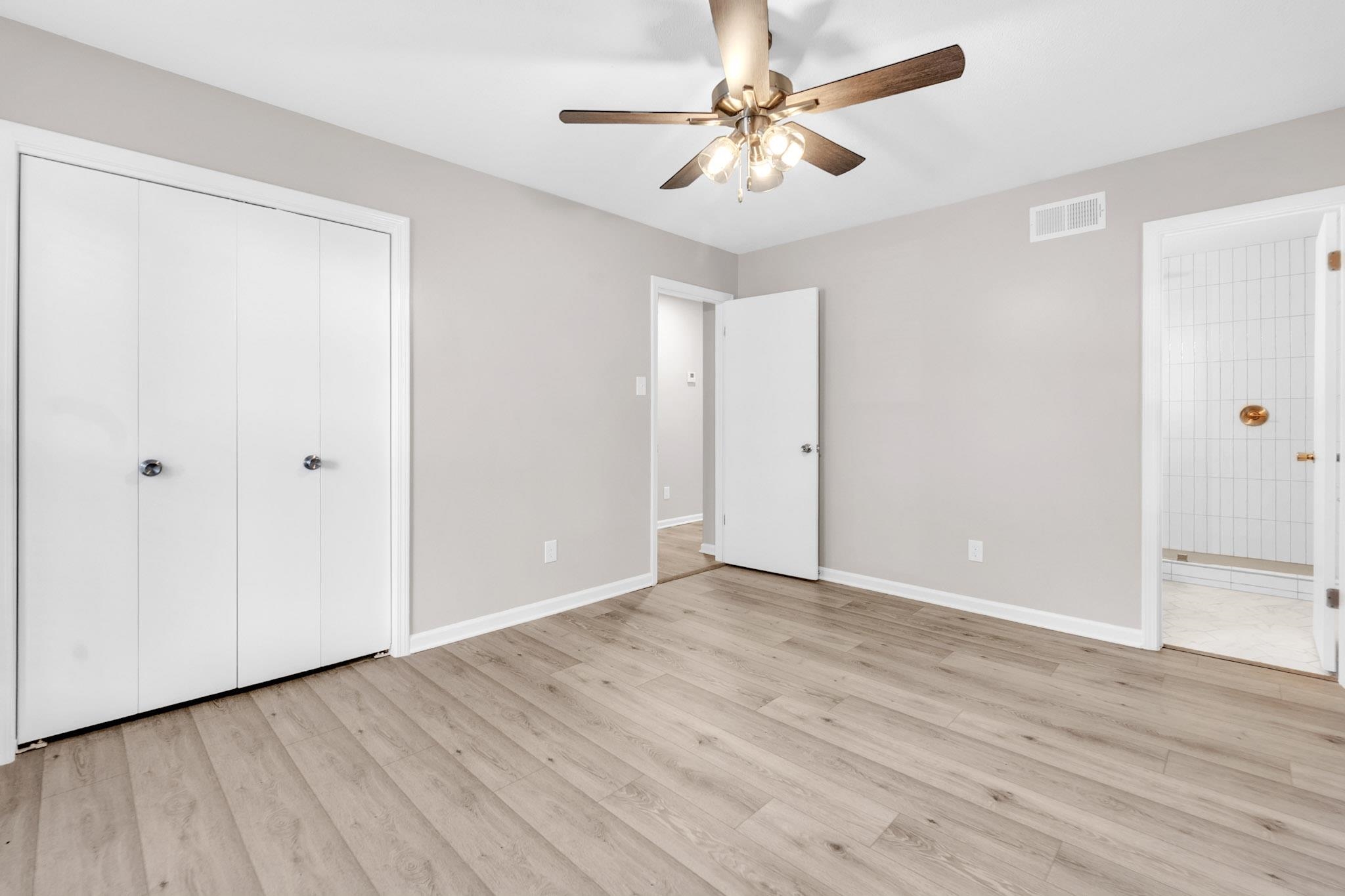 2556 Lynnfield Road Memphis, TN 38119 - Photo 8 of 24 Unfurnished bedroom featuring light wood-style floors, ceiling fan, and ensuite bathroom