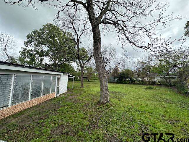 3023 Mistletoe Circle Tyler, TX 75701 - Photo 14 of 14 a view of a backyard with large trees