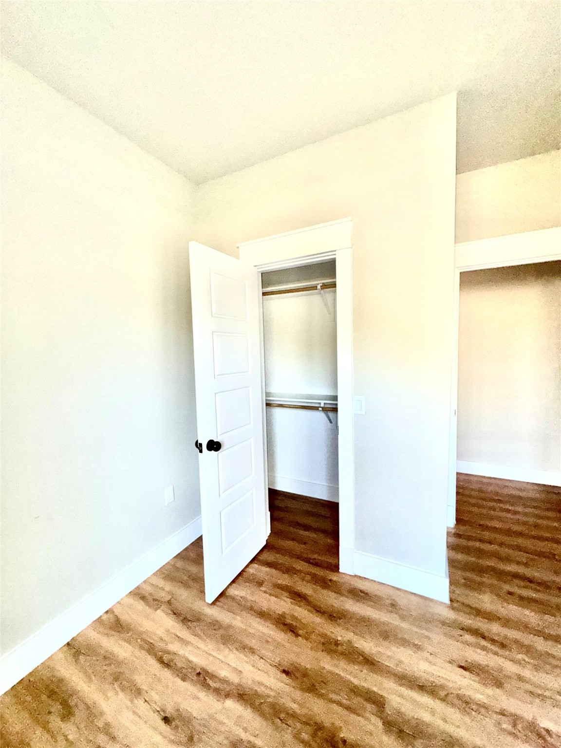204 Booker T Washington Street, Unit B Conroe, TX 77301 - Photo 6 of 13 a view of a room with wooden floor and a white wall