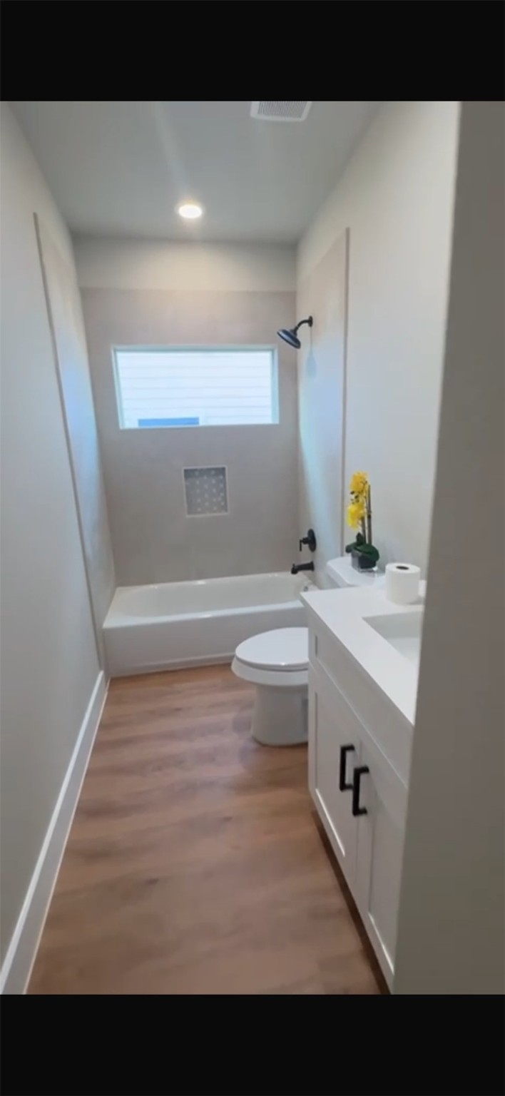 204 Booker T Washington Street, Unit B Conroe, TX 77301 - Photo 10 of 13 a bathroom with a sink and a bathtub