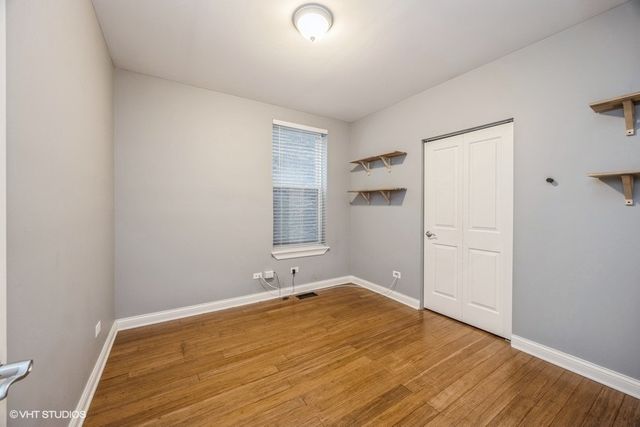 a view of a room with wooden floor and cabinet