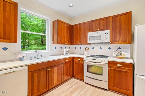 a kitchen with a sink stove top oven and cabinets