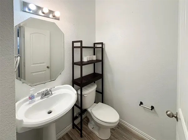 a bathroom with a sink mirror and toilet
