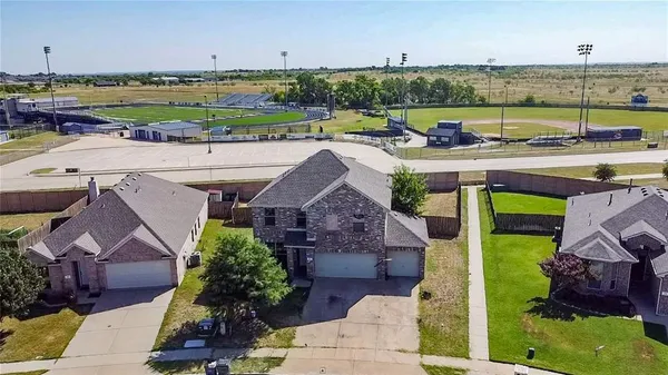an aerial view of a house with a garden and lake view