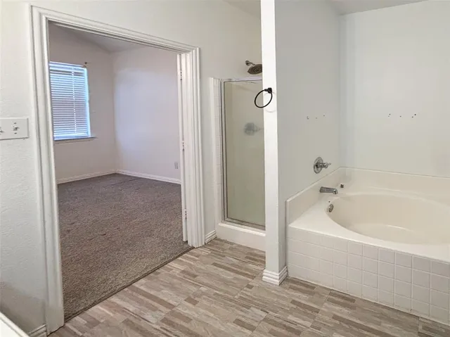 a bathroom with a bathtub and a shower
