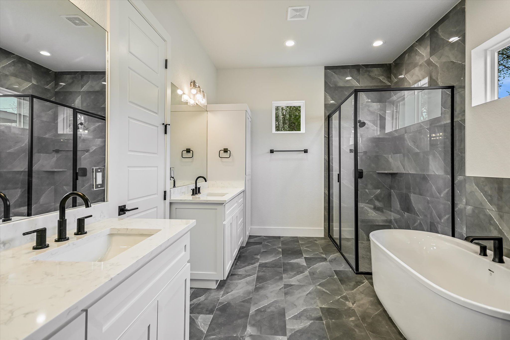 32 Peace Pipe Wimberley, TX 78676 - Photo 14 of 20 Bathroom featuring two vanities, a marble finish shower, a freestanding tub, plenty of natural light, and recessed lighting