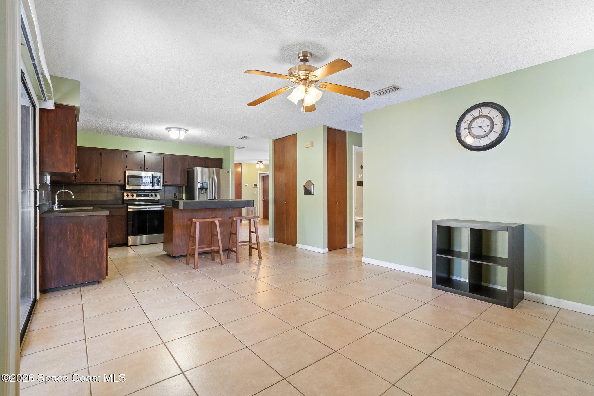 4550 Piedras Street Cocoa, FL 32927 - Photo 16 of 53 a view of kitchen with stainless steel appliances kitchen island granite countertop a refrigerator and a stove top oven