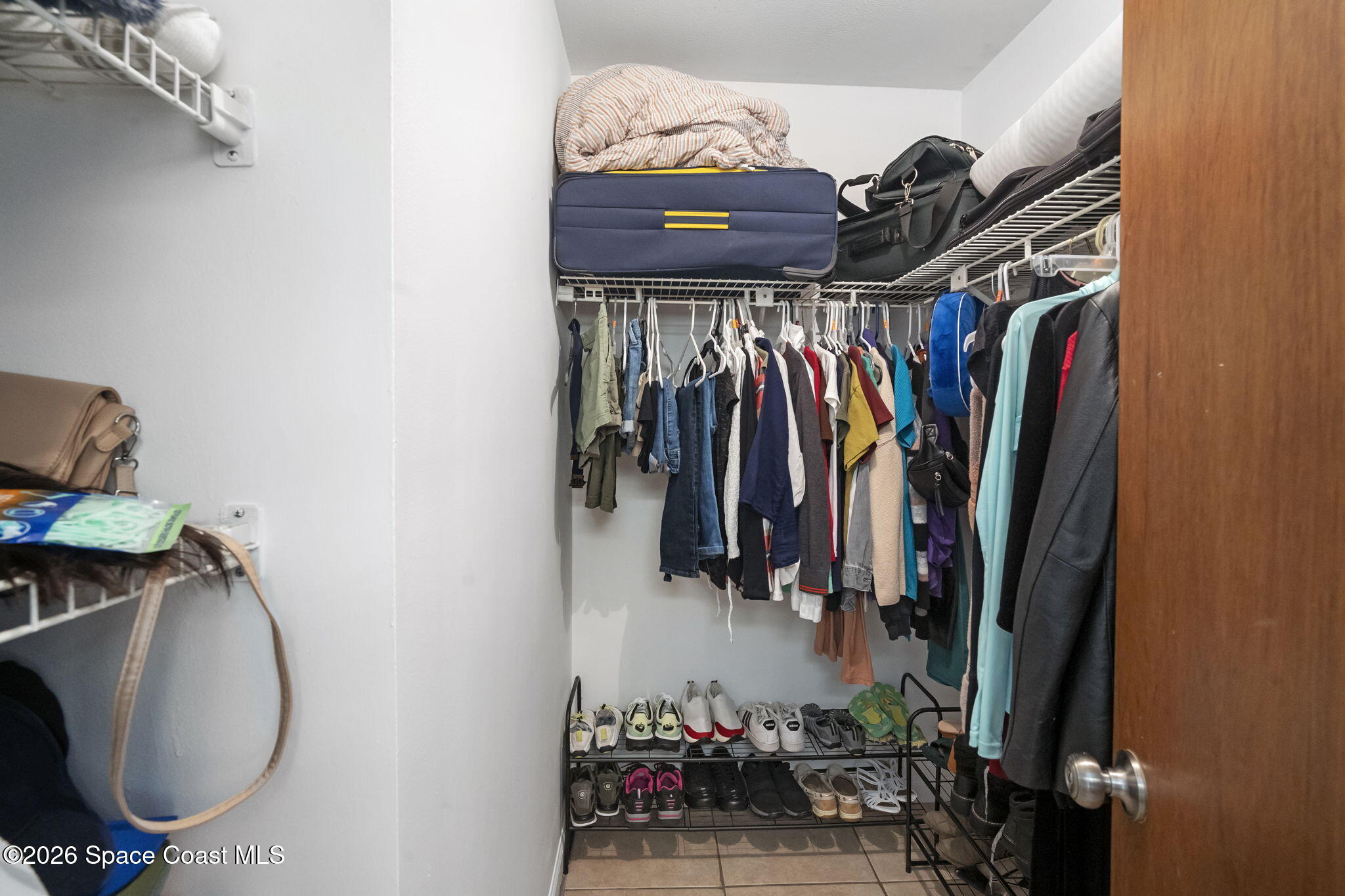 4550 Piedras Street Cocoa, FL 32927 - Photo 25 of 53 a view of walk in closet with clothes and shoes