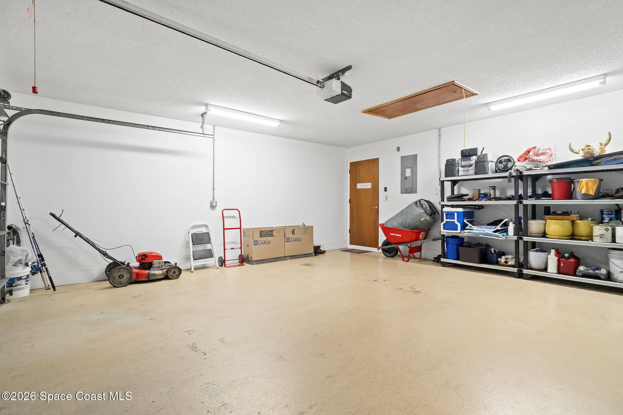 4550 Piedras Street Cocoa, FL 32927 - Photo 34 of 53 a view of a garage with a flat screen tv