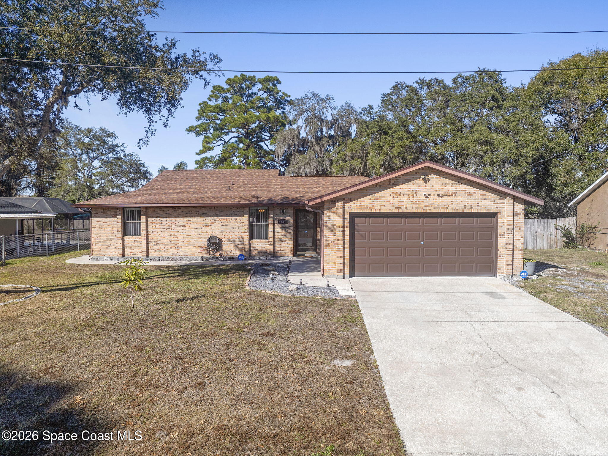 4550 Piedras Street Cocoa, FL 32927 - Photo 45 of 53 a front view of a house with a yard and garage
