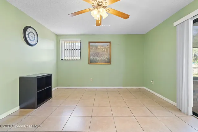 a view of a livingroom with furniture and chandelier fan