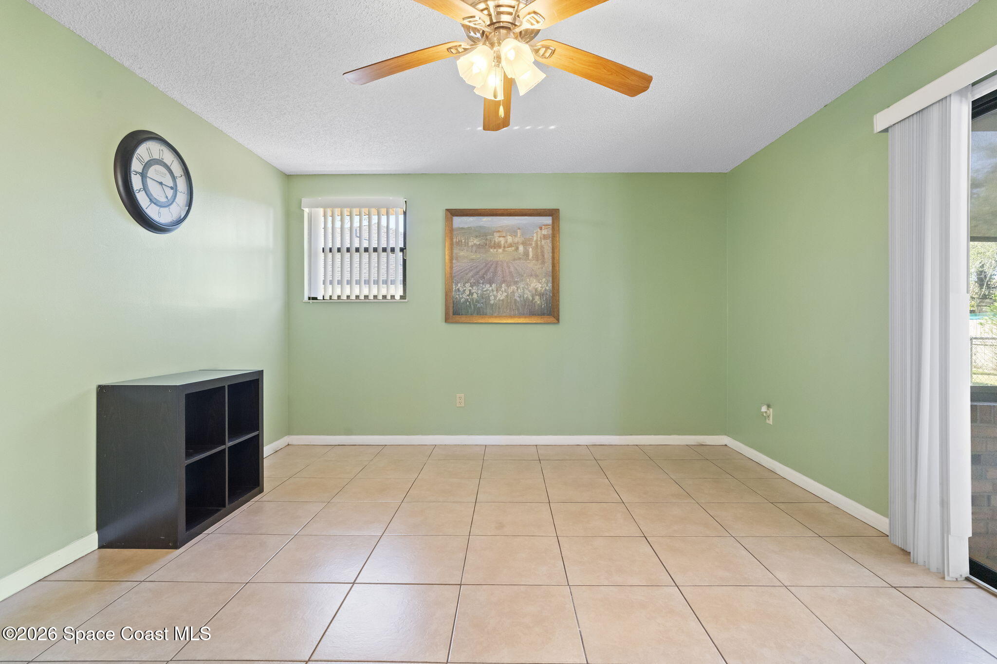 4550 Piedras Street Cocoa, FL 32927 - Photo 8 of 53 a view of an empty room with window and a kitchen