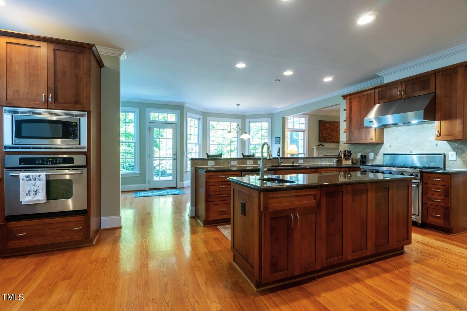 4211 Forest Edge Trail Durham, NC 27705 - Photo 15 of 62 a kitchen with stainless steel appliances granite countertop a stove a sink and a microwave