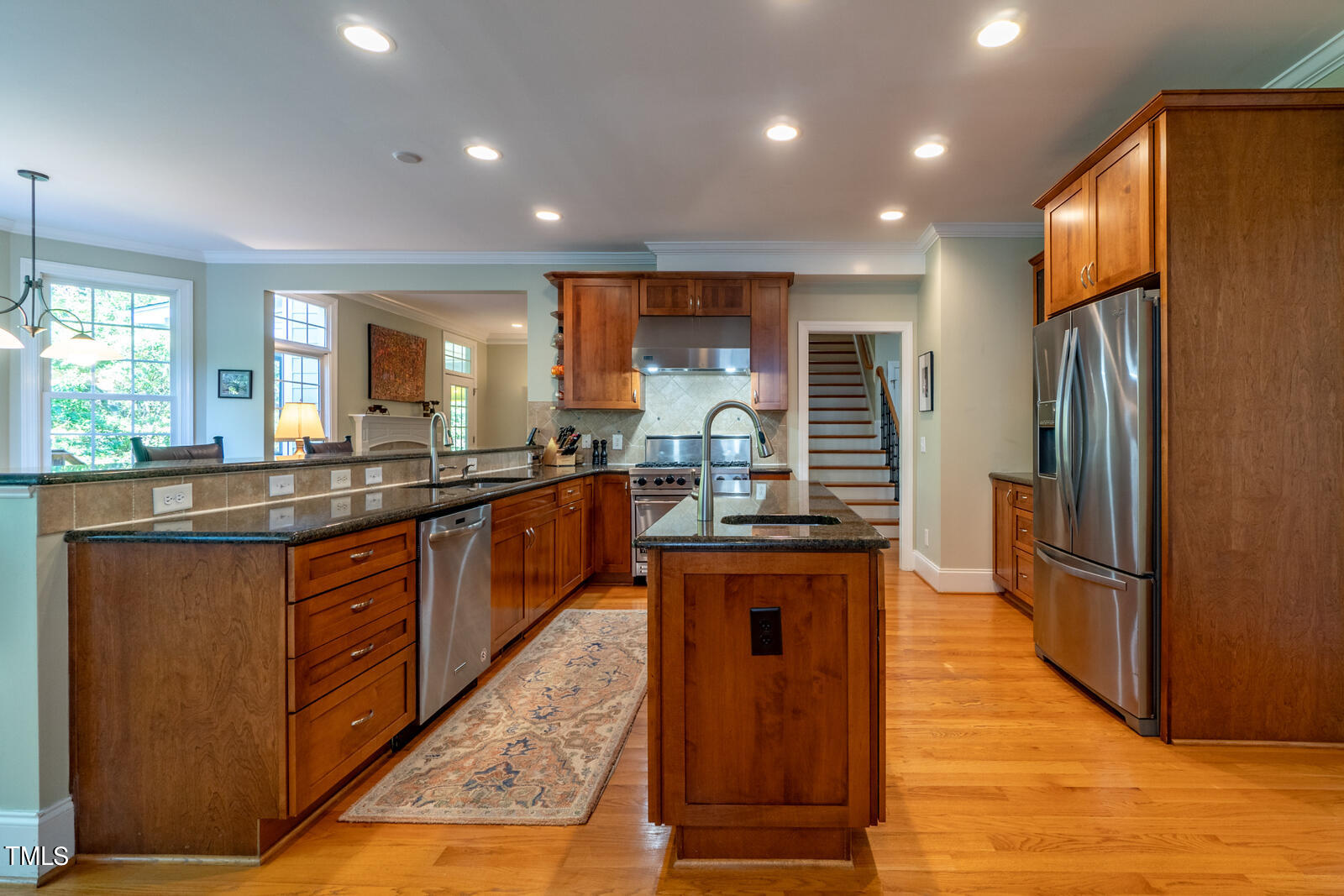 4211 Forest Edge Trail Durham, NC 27705 - Photo 16 of 62 a kitchen with stainless steel appliances granite countertop a refrigerator a sink dishwasher a oven and a large countertops with wooden floor