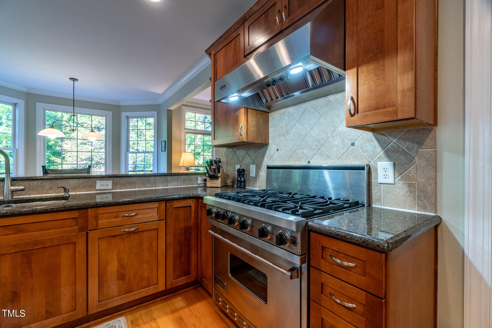 4211 Forest Edge Trail Durham, NC 27705 - Photo 17 of 62 a kitchen with stainless steel appliances granite countertop a stove a sink and a microwave