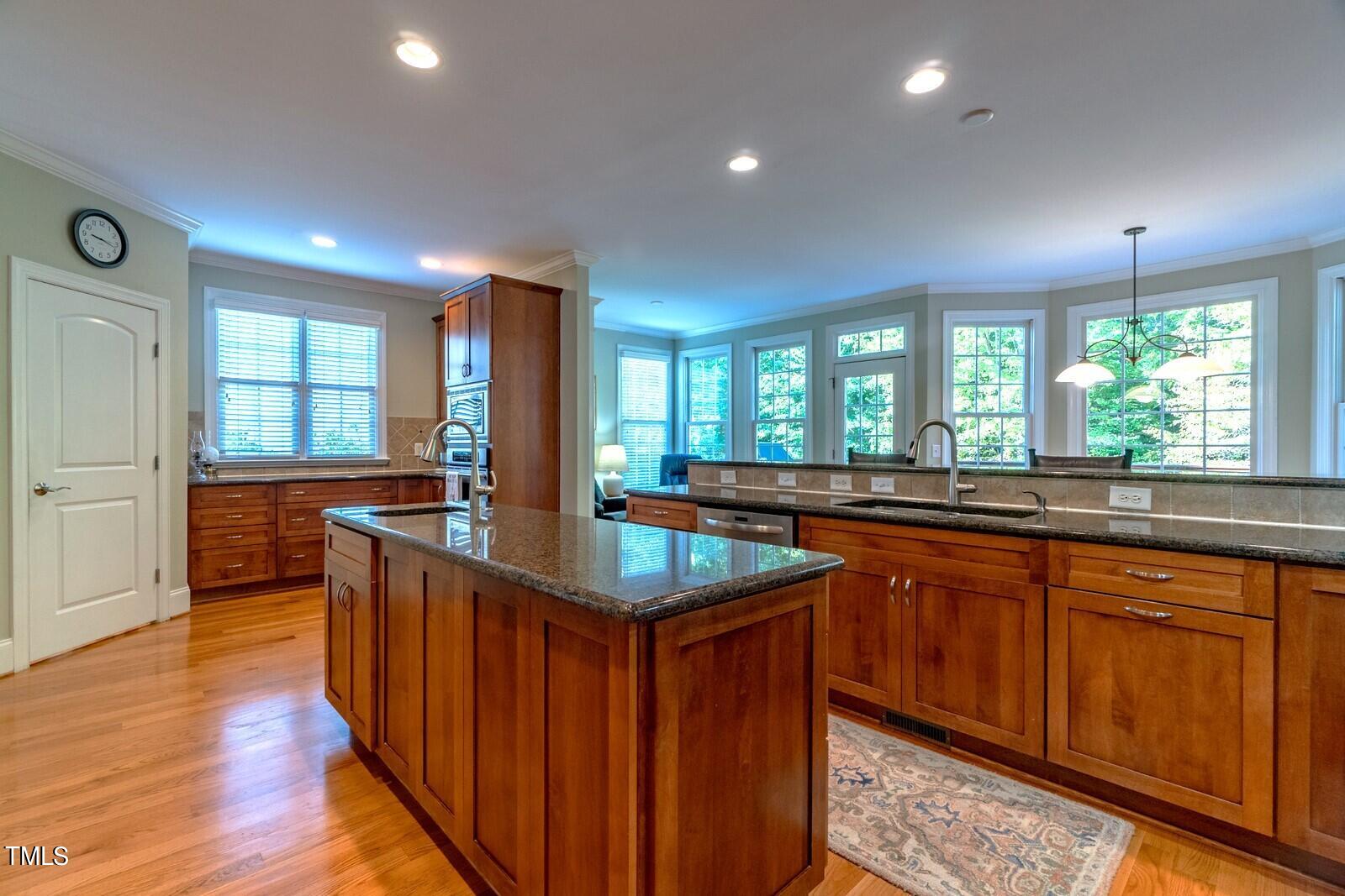 4211 Forest Edge Trail Durham, NC 27705 - Photo 19 of 62 a kitchen with counter top space sink and wooden floor