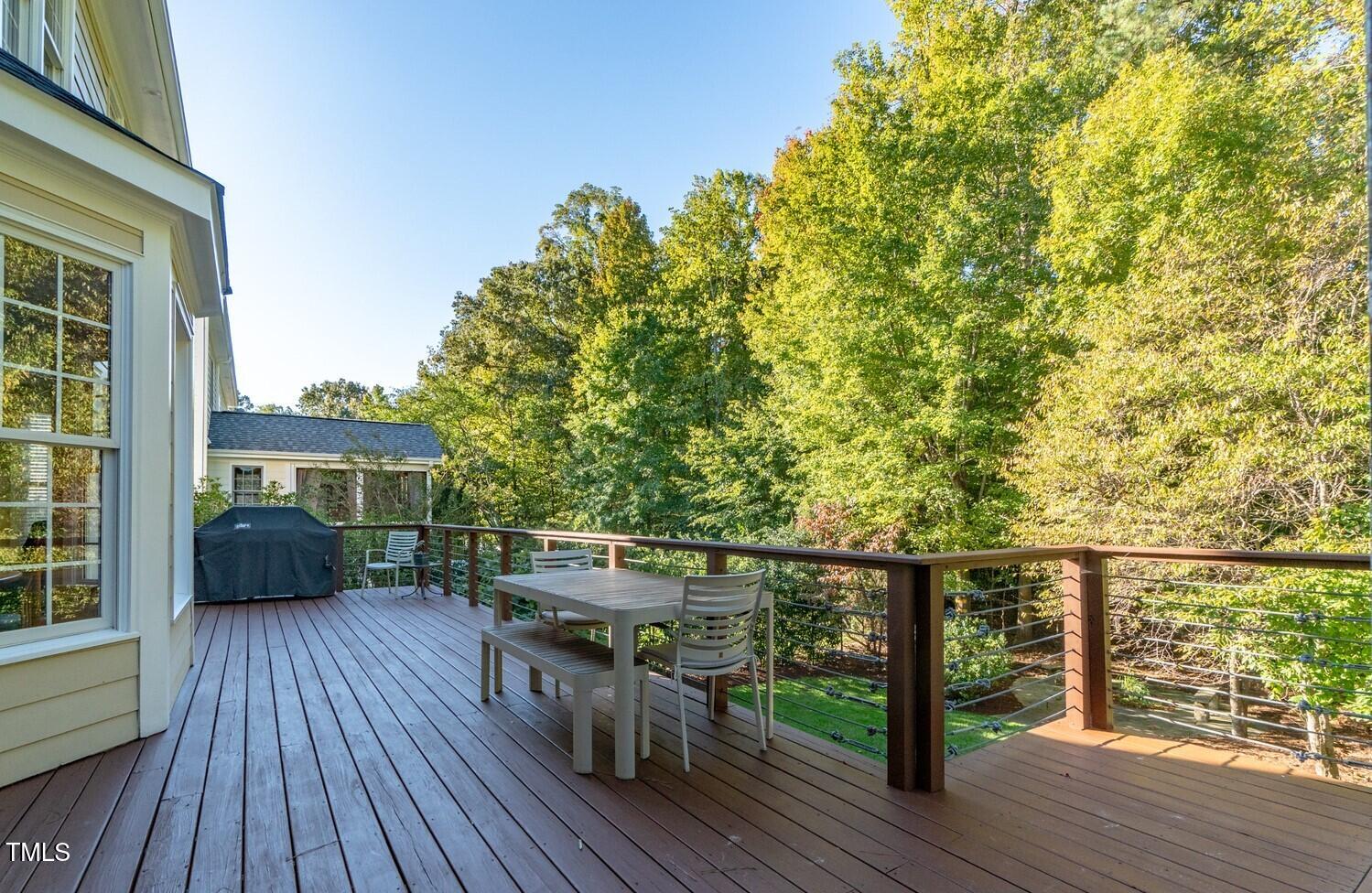 4211 Forest Edge Trail Durham, NC 27705 - Photo 24 of 62 a view of house with deck outdoor seating and trees in the background